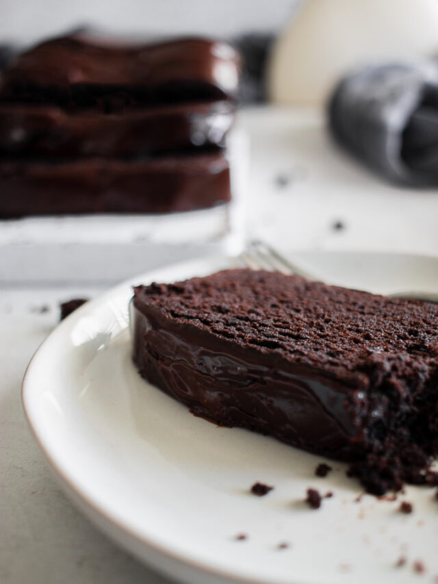 cropped chocolate pound cake recipe on white plate blog edit