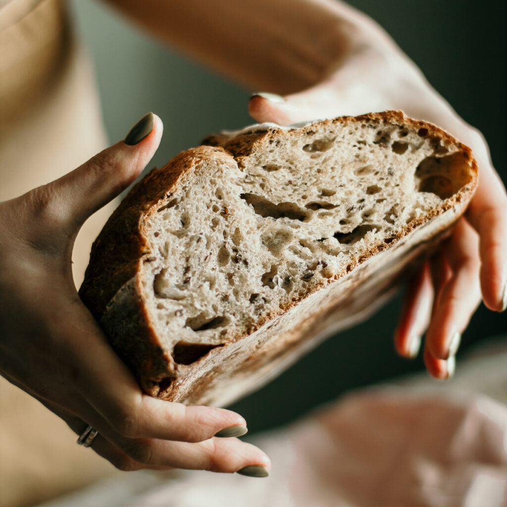 woman holding sourdough bread blog edit